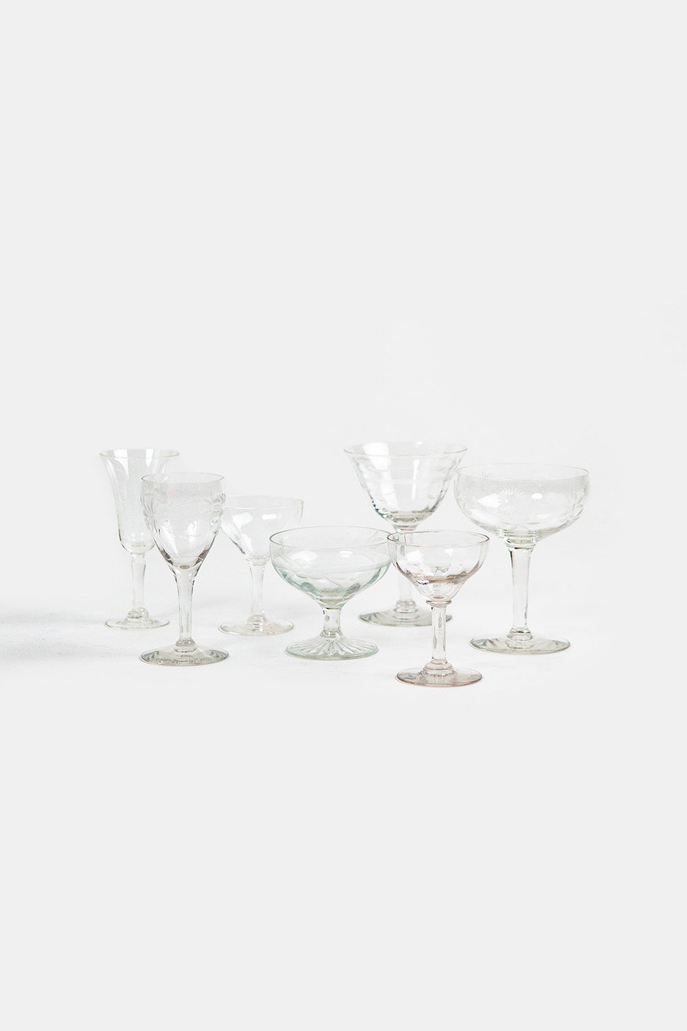Set of clear glass cocktail glasses on a white background