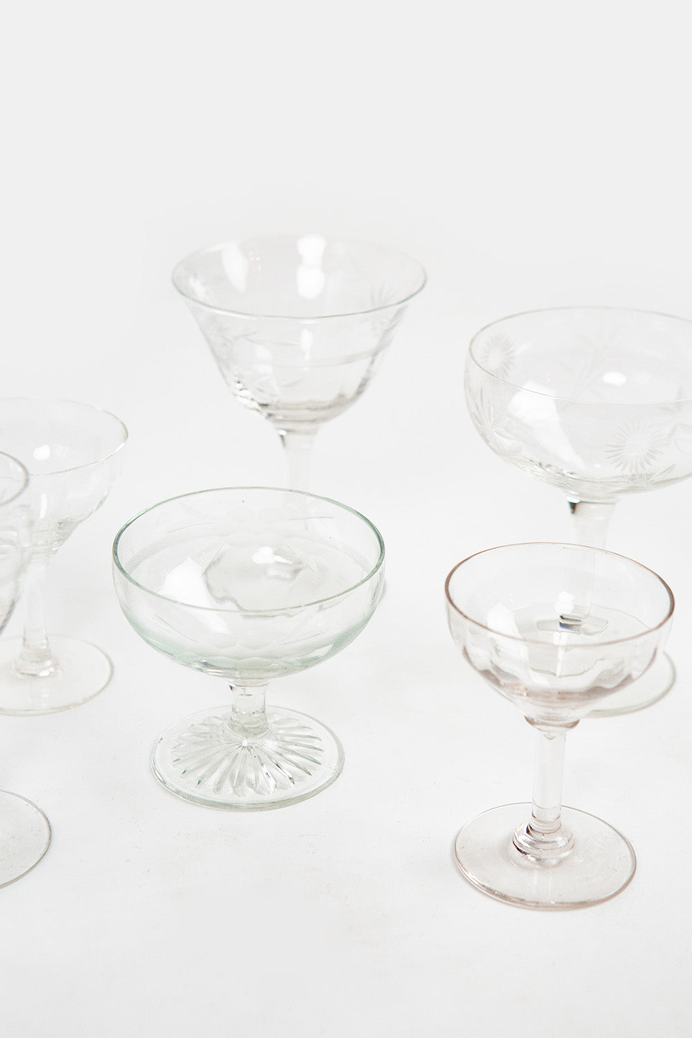 Clear cocktail glasses on a white background