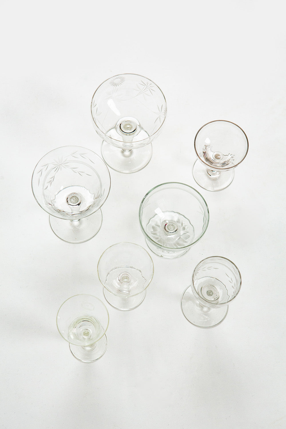 Set of clear glass stemware on a white background